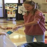 Natalie Allison and Kinley Hanfelder work on the FBLA recycling project