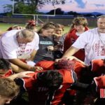Asst MHS Tiger Coach Tim Cothran leads the teams, and attendees in Prayer.