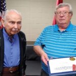 Alma Mayor presents Fred Potter with award from the Secretary of State.