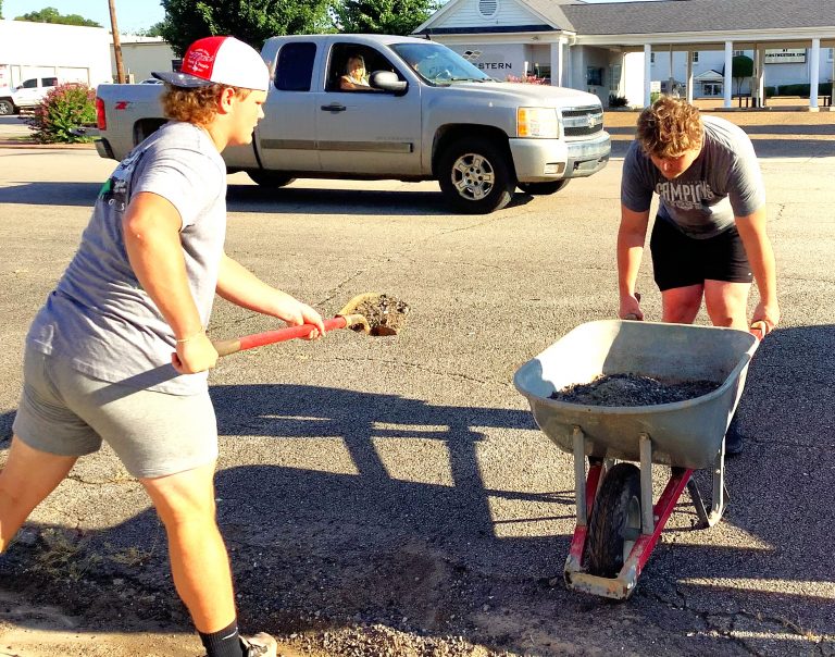 Booneville Football Players Serve Community as Part of “Bearcats Boot Camp”
